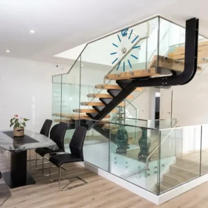 Floating wooden stairs with frameless pin-supported glass balustrade.